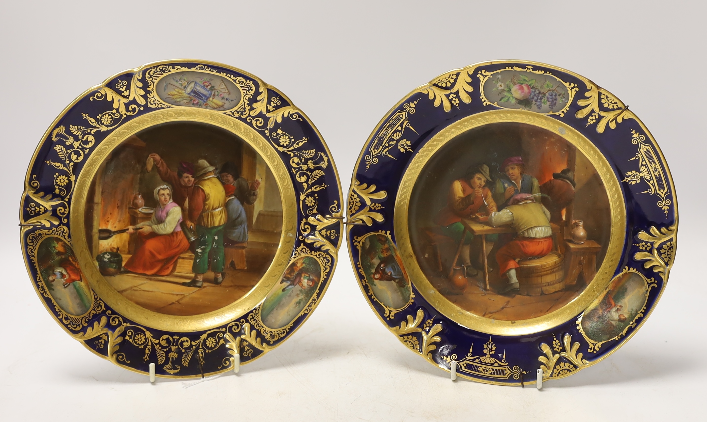 Two 19th century Vienna style plates, with painted central cartouche tavern scenes after Teniers, 22cm diameter